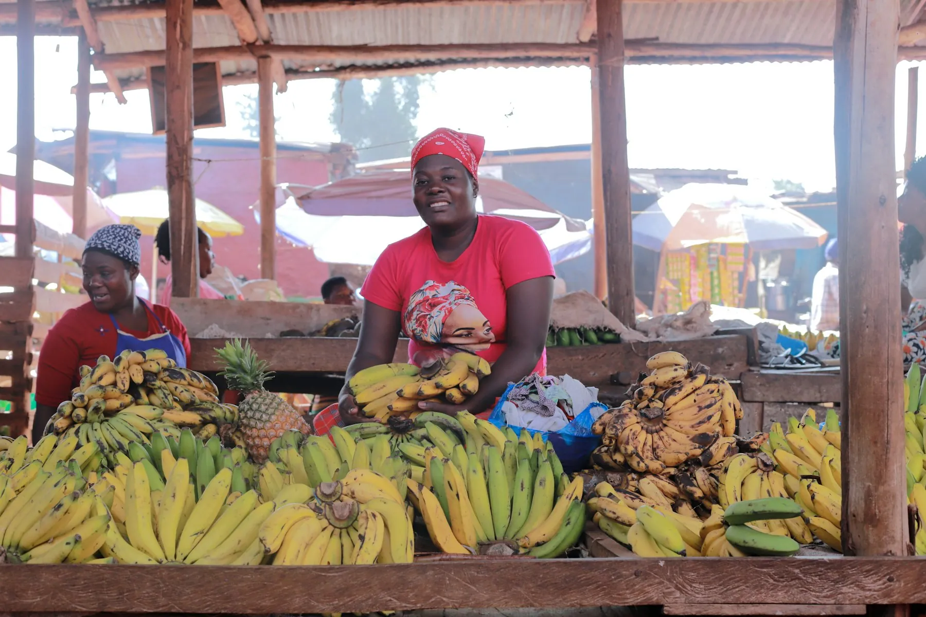 Smiling vendors at a busy market stall